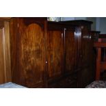 A 19TH CENTURY MAHOGANY INVERTED BREAKFRONT WARDROBE WITH CENTRE SECTION OF TWO CUPBOARD DOORS
