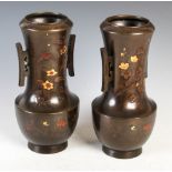 Pair of Japanese bronze twin-handled vases, Meiji Period, with incised and relief decoration of