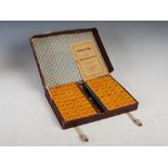 A cased vintage Chinese 'Game of Four Winds' complete with Mahjong set, with directions booklet by