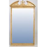 Late 19th/ early 20th century gilt gesso wall/ hall mirror, with a broken arch pediment with urn