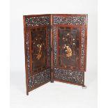 A Japanese darkwood and inlaid lacquer two-fold screen, late Meiji / Taisho period, the two
