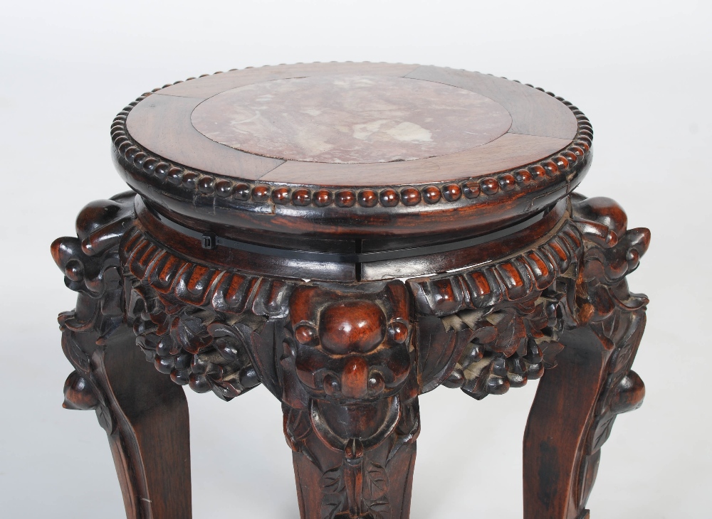 A Chinese carved darkwood stand, Qing Dynasty, the round top inset with marble, over carved and - Image 5 of 5