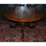 A Victorian walnut and marquetry inlaid snap top supper table, the hinged circular top with inlaid