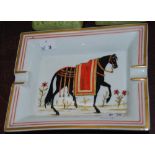 Hermes ceramic ashtray, the bowl decorated with a hand-painted figure of a black horse with red