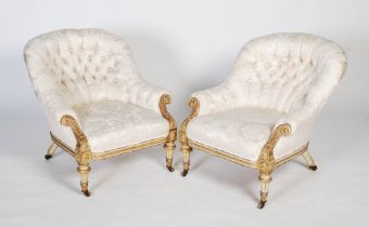 A pair of French Regency style button backed giltwood armchairs, early 20th century, each with a