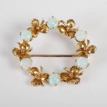 A 9ct gold and opal circular brooch, set with six opal cabochons divided by shamrocks, gross