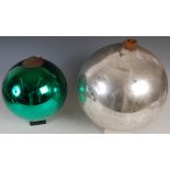 Two late 19th/ early 20th century glass mirror witches balls, comprising; a large silvered ball