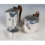 Three pieces of Picquot ware, to include a tea pot, hot water jug and a sugar bowl in stainless