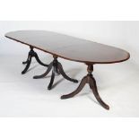 An early 20th century mahogany triple pillar D-end dining table, the top with figured mahogany and