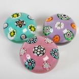 A group of three small Paul Ysart paperweights, each decorated with colourful millefiori canes,