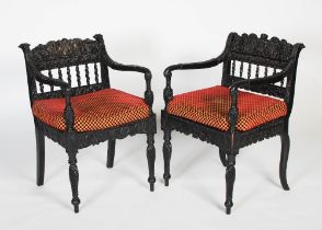 A pair of matched Anglo-Indian ebony armchairs, mid 19th century, possibly Ceylonese, the frames