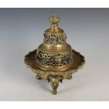 A Chinese bronze incense burner and cover, Qing Dynasty, the flower shaped bowl raised on three