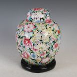 A Chinese porcelain black ground famille rose millefleurs jar and cover, late 19th/ early 20th