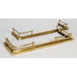 Two brass fenders, both of ball and rail design, one extendable, each 136cm long.