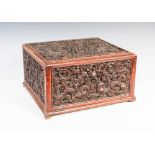 A Chinese carved wood dragon document box, Qing Dynasty, formed with five relief carved panels