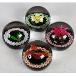 A limited edition set of Four Seasons Caithness Glass paperweights designed by Colin Terris and made