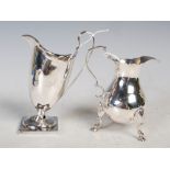 Antique London silver cream jug on three scroll supports, together with a London silver helmet-
