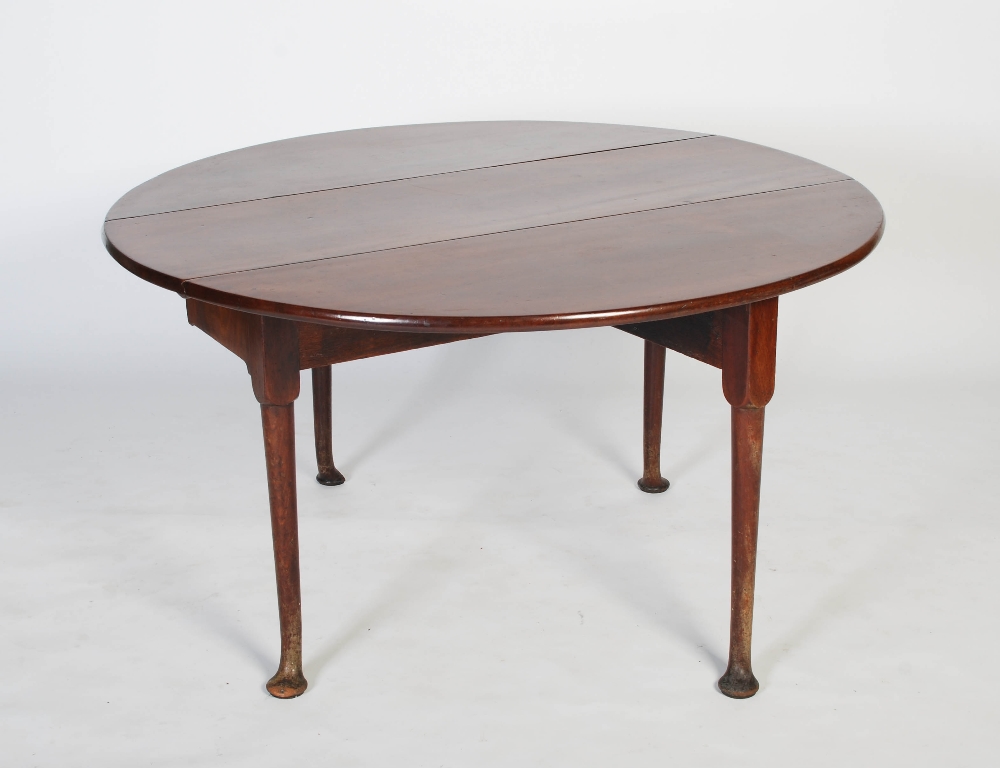 A George II mahogany dining table, circa 1740-60, the oval drop leaf top on four cabriole legs - Image 4 of 7