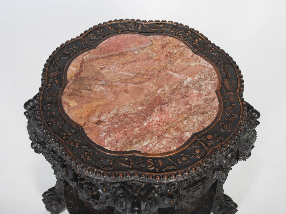 A Chinese carved darkwood stand, Qing Dynasty, the round top carved with a frieze of auspicious - Image 2 of 7