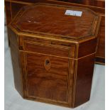 A 19th century octagonal strung plum pudding mahogany veneered tea caddy, with fitted lid to the