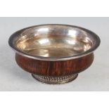 A Tibetan white metal mounted burrwood bowl, late 19th / early 20th century, of circular form, the