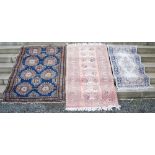 A blue ground Persian rug, the rectangular field centred with two rows of octagonal-shaped