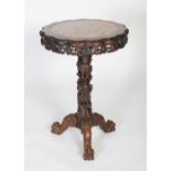 A Chinese carved darkwood occasional table, Qing Dynasty, the lobbed round top inset with marble,