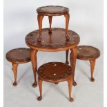 A 20th century South-East Asian carved teak nest of tables, each of round form with carved floral