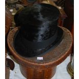 A 20th century black silk top hat, by Henry Heath Ltd, London, the cream silk lining with gilt