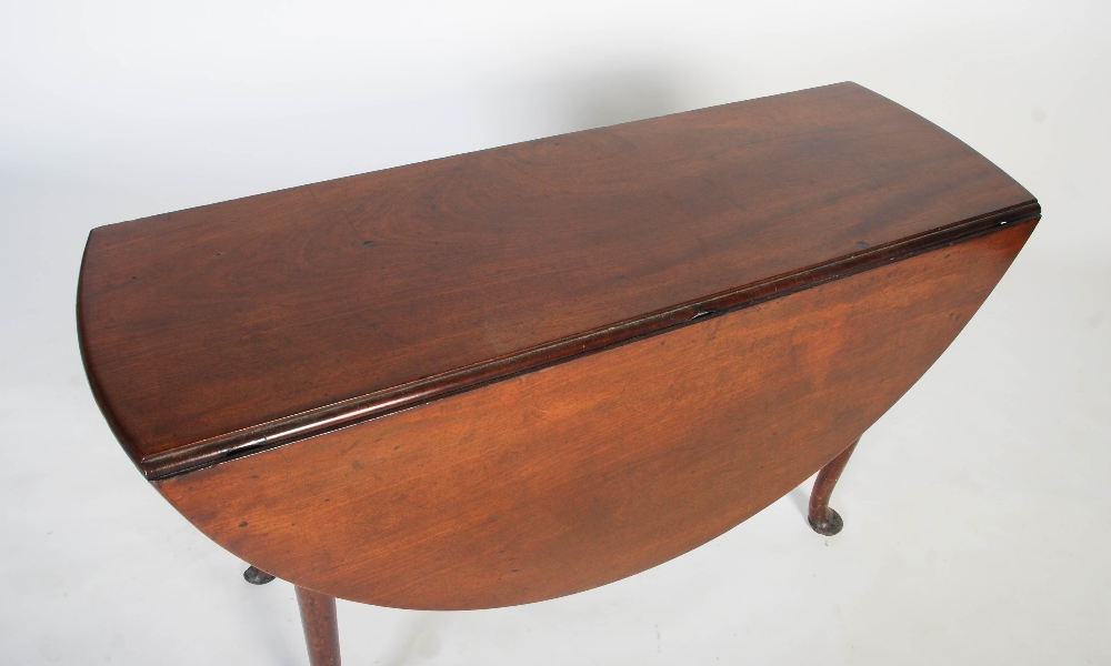 A George II mahogany dining table, circa 1740-60, the oval drop leaf top on four cabriole legs - Image 2 of 7