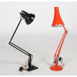Two Anglepoise style articulated desk lamps, one enamelled in red the other enamelled in black,