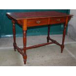 An early 20th century mahogany library table, the top with tooled red leather skiver, with two