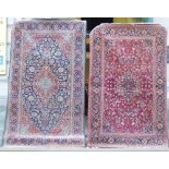 Two Isfahan rugs, Central Persia, one with rust red field, the other with indigo field, each with