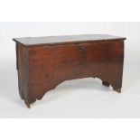 A late 17th century oak plank coffer, of plain rectangular form, the top with piecrust outer edges