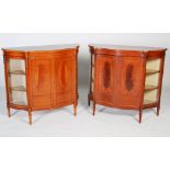 A pair of early 20th century Sheraton Revival satinwood and marquetry serpentine side cabinets, each