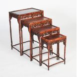 A Chinese darkwood quartetto of tables, 20th century, the bamboo carved tops each with a carved