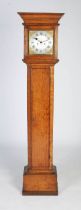 An 18th century English oak longcase clock, the caddy top hood with moulded pediment, the plain