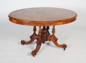A Victorian walnut, yew and parquetry centre table, the oval shaped top with broad inlaid outer