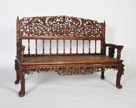 A Chinese carved darkwood bench, Qing Dynasty, the back richly carved in relief with two dragons