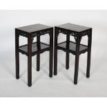 A pair of Chinese carved darkwood stands, Qing Dynasty, the rectangular tops over carved and pierced