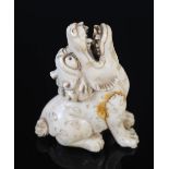 Japanese ivory Netsuke in the form of a Kylin, Meiji Period, recumbent with head raised, 4cm high