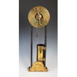 A late 17th century style English oak and brass water clock / clepsydra, formed of a brass dial with