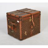 An early 20th century Louis Vuitton monogramed canvas, leather and brass bound travel trunk, of