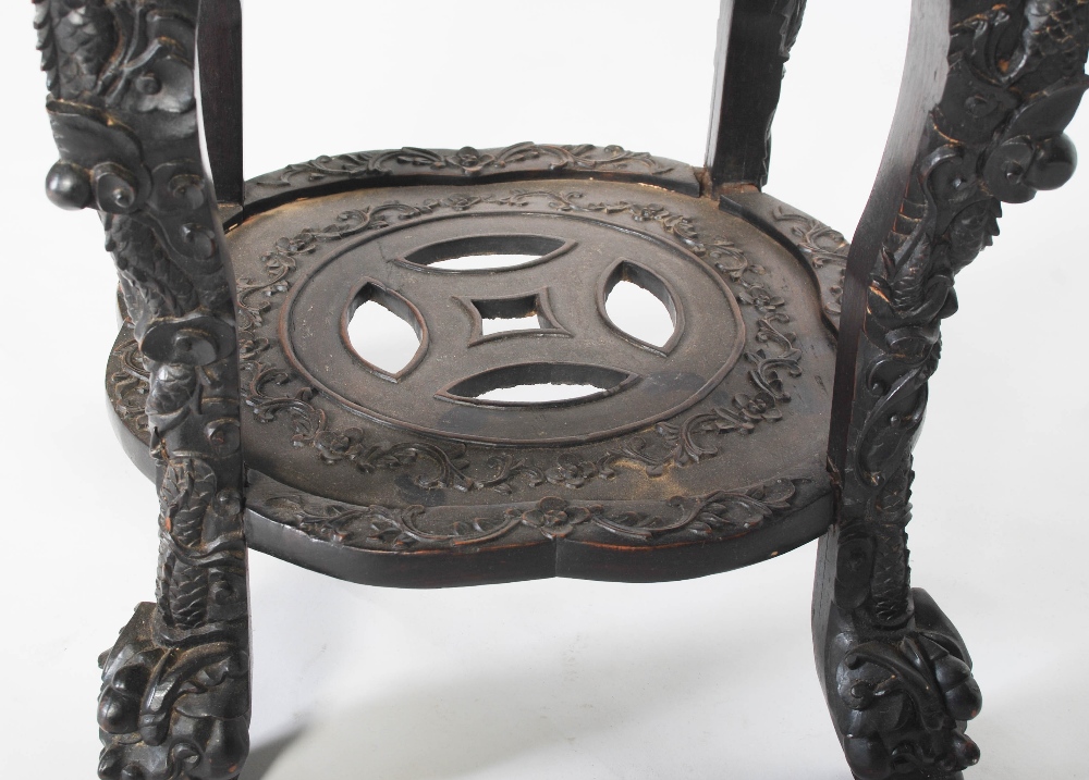 A Chinese carved darkwood stand, Qing Dynasty, the round top carved with a frieze of auspicious - Image 5 of 7