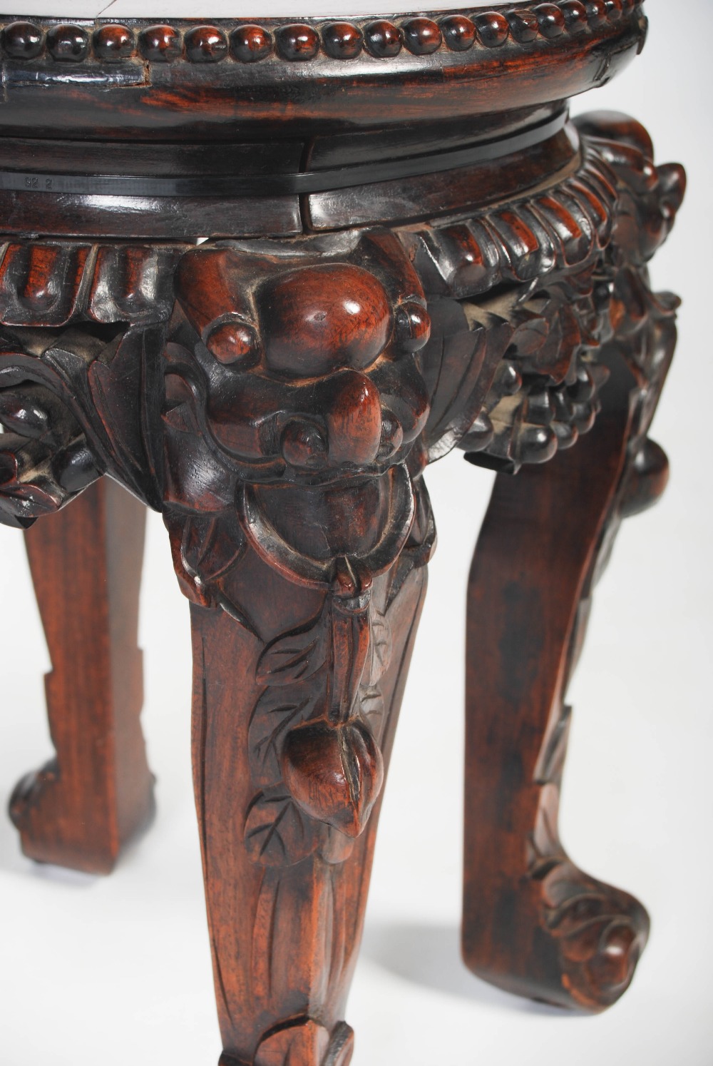 A Chinese carved darkwood stand, Qing Dynasty, the round top inset with marble, over carved and - Image 3 of 5