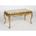 A French Louis XV style giltwood and caned window seat, early 20th century, of rectangular form, the