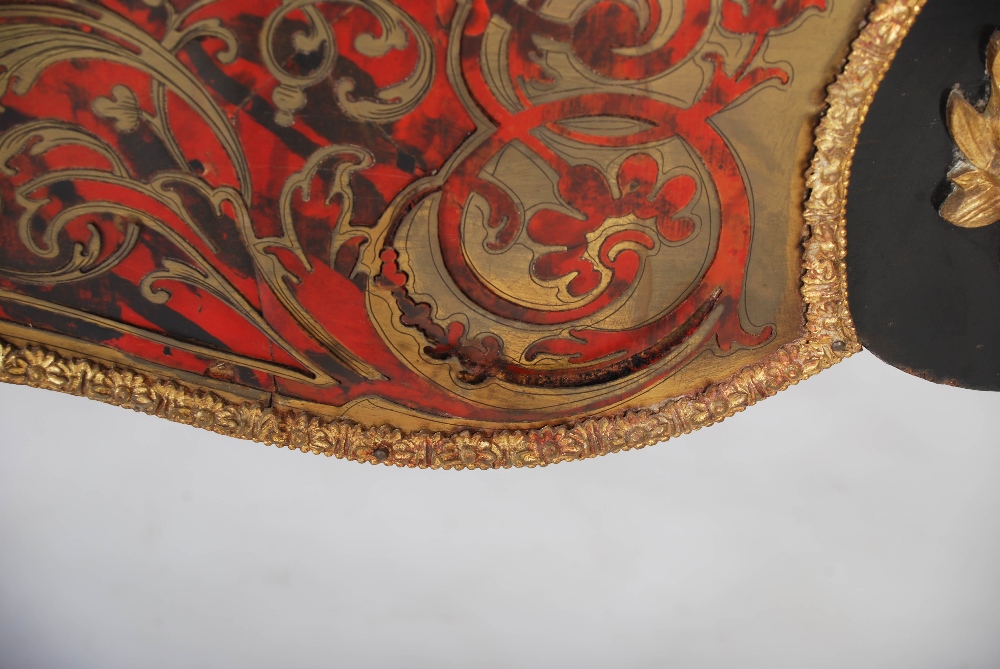 A 19th century ebonised and gilt metal mounted boulle centre table. The shaped oval top with gilt - Image 4 of 9