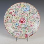 A Chinese porcelain famille rose millefleurs dish, late Qing Dynasty, decorated with peony,