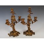 Pair of 19th century Continental Rococo style ormolu three-light candelabra, each with scrolling