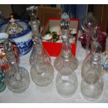 Group of seven glass decanters, including three 19th century plain tapering examples with airdrop